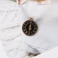 Detailed macro view of vintage clock style alloy charm with black enamel and gold numerals - Fairytale Girl (Black) / Black