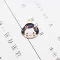 Macro view of cartoon girl enamel charm pendant for DIY necklace and jewelry making - Japanese Doll Head
