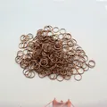 Close-up of antique bronze jump rings for DIY jewelry making and craft connections - Antique Red Copper