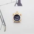 Detail of a mini golden alarm clock pendant with black enamel finish for DIY jewelry - Black