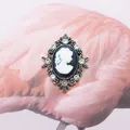 Vintage silver cameo oval brooch with a white lady profile and sparkling rhinestones - White