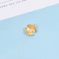 Detailed macro view of a gold shell pendant with a white pearl for DIY jewelry making - Gold