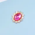 Macro view of pink oval rhinestone with small crystal halo and gold-tone metal backing - Rose Red