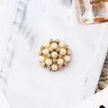 Exquisite gold alloy flower brooch with faux pearls and rhinestones on denim background - Gold