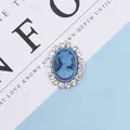 Detailed macro view of vintage blue oval cameo with silver base and rhinestone border - Blue