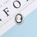 Detail of vintage cameo pendant with rhinestone edges for DIY hair accessories - White