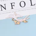 Detail of a white enamel bird brooch with golden flower branch for DIY hair accessories - Right Side White
