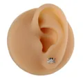 Macro detail of a silver crab stud earring with a clear zircon on a silicone ear model - Silver Crab Style (B1392)