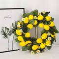 Artificial lemon wreath with yellow fruit and green leaves on a silver metal stand - Artificial Lemon Wreath