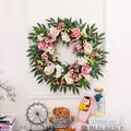 Detailed view of handmade rose floral wreath with pink flowers and lush green foliage - Champagne Pink Rose Wreath