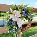 Spring wreath with blue flowers, green leaves and a large bow on a rustic vine base - Blue Wreath Style