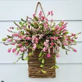 Pink hydrangea floral arrangement in rustic hanging wicker basket with twine on wood - Red