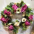 Detail of pink roses and white daisies on a lush spring artificial wreath for front door - Style C