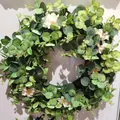Detailed view of artificial eucalyptus wreath with pink peonies for front door decor - Style A