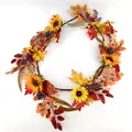 Detailed close-up of autumn wreath with sunflowers, pine cones and orange maple leaves - Sunflower Pinecone Style