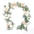 Close-up of champagne and cream artificial roses with eucalyptus leaves for wedding decor - Pink