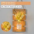 Wall-mounted wood board with HOME lettering, glass vase, and yellow artificial flowers - Yellow Board with Forget-me-not