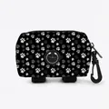 Black pet waste bag dispenser with paw prints, featuring a rubber outlet and hooks - Black With Grey White Paw Prints (01)