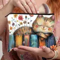 Handheld cosmetic bag with cute cartoon orange cat and colorful flower art print - Leisure Nap