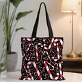 Christmas canvas tote bag featuring red and white candy cane patterns on black background - Black Red and White Striped Candy Cane (08)