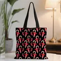 Black Christmas tote bag featuring festive candy cane print and durable shoulder straps - Black Bow Candy Cane (03)