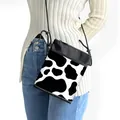Leopard and cow print crossbody phone bag with adjustable rope strap for daily travel - Black White Cow Print