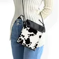 Crossbody bag with cow print pattern and adjustable black shoulder strap for women - Black and White Spliced Cow