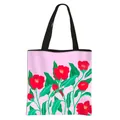 Pink floral tote bag with red camellia print and black shoulder straps on white background - Pink Camellia