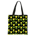 Floral tote bag for women featuring yellow flower pattern on black polyester fabric - Yellow Tulip