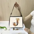 Off-white tote bag featuring a floral letter J print and adjustable black straps - J10 (Letter J)