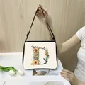 Minimalist canvas tote bag with floral letter D print and adjustable black shoulder strap - D04 (Letter D)