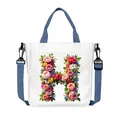White canvas tote bag featuring floral letter H print with adjustable blue shoulder strap - Flower Letter H Style(08)