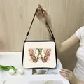 Minimalist canvas tote bag with floral letter W print and black adjustable shoulder strap - W23 (Letter W)