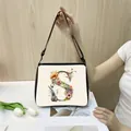 Cream polyester shoulder bag featuring a large floral letter S design and black strap - S19 (Letter S)