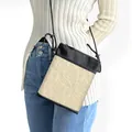 Vintage beige jacquard floral mini crossbody phone bag with black cord strap shown on model - Beige Damascus Jacquard (23)