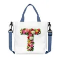 Canvas tote bag with floral letter T print, featuring blue handles and adjustable strap - Flower Letter T Style(20)