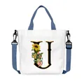 Borsa tote in tela bianca con lettera U floreale e tracolla blu regolabile e comoda - Lettera U(U21)