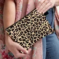 Leopard print makeup bag with black zipper and side handle held by a model - Classic Leopard Style (02)