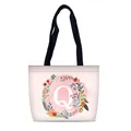 Pink canvas tote bag with floral letter Q print and black woven handles for travel - Style Q