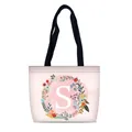 Pink canvas tote bag featuring floral wreath with letter S and black handles - Style S