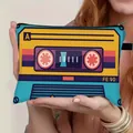 Portable makeup bag with vintage cassette tape print held by hands for travel storage - Yellow Blue Purple Retro Cassette Style (01)