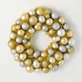 Detail of Christmas wreath with gold and silver ornaments on a white background - Gold & Silver