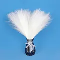 Detailed close-up of fluffy white artificial pampas grass in a faceted grey glass vase - White