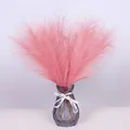 Pink artificial pampas grass in a purple faceted glass vase with a white decorative ribbon - Dusty Pink
