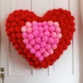 Valentine's Day heart wreath with red and pink plush pom-poms hanging on a white door - Standard Type / Red with Pink Hearts