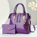 Deep purple crocodile pattern handbag set with glossy finish and tassel detail - Purple