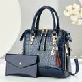 Dark blue crocodile pattern patent leather handbag set with cat charm and gold hardware - Blue