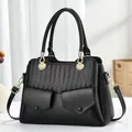 Elegante schwarze Damen-Handtasche mit gewebter Struktur und goldenen Metall-Elementen - Schwarz
