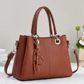 Brown handbag with geometric embossing and adjustable shoulder strap for women - Earthy Yellow