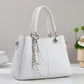 Elegant white faux leather handbag with geometric embossed pattern and stylish strap - Off White